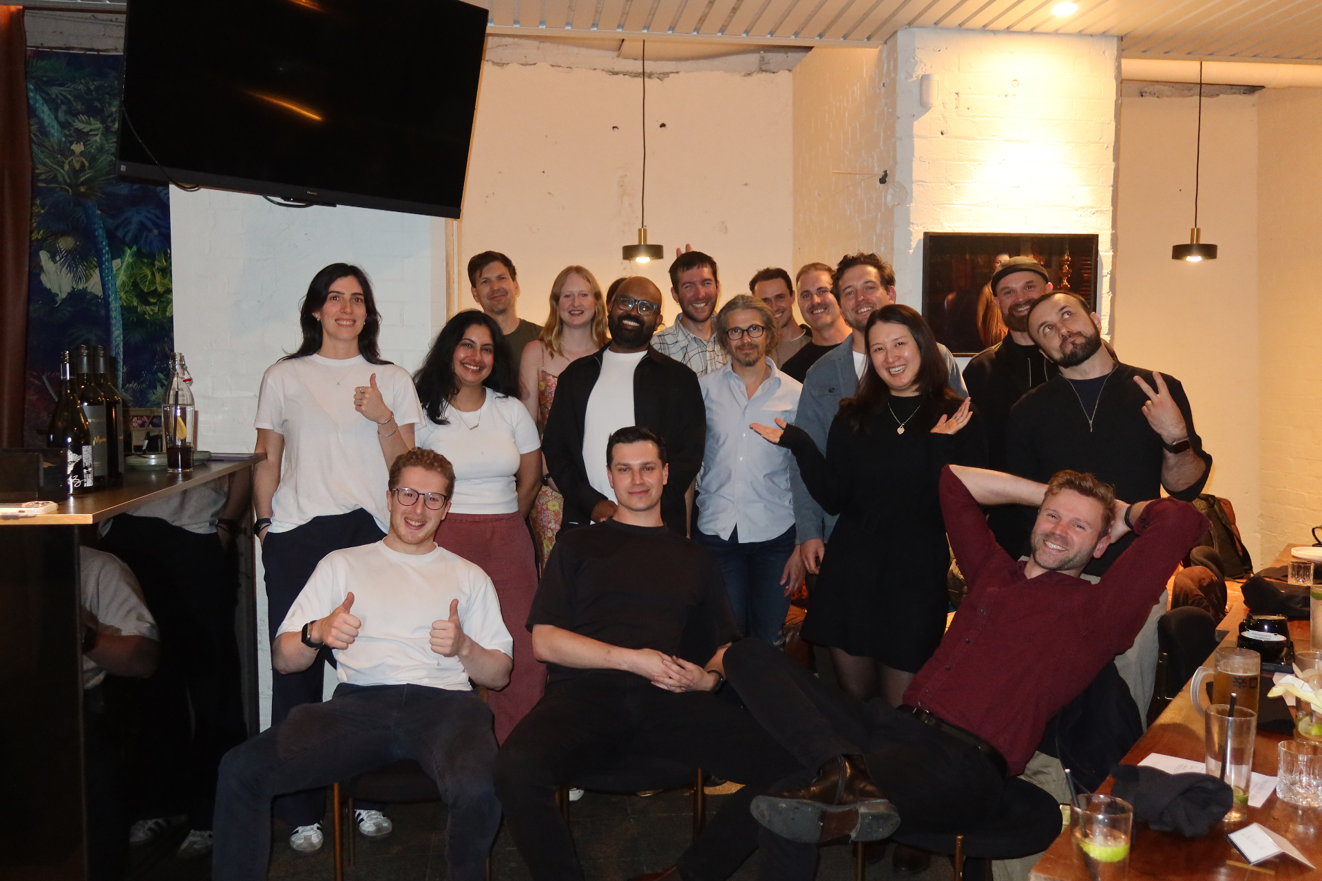 A group of attendees laughing together at an in-person event